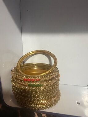 Stack of Gold Tone Indian Style Bangles with Red and Green Accents